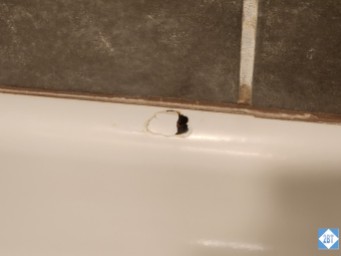 Hole in the side of the tub in the master bath